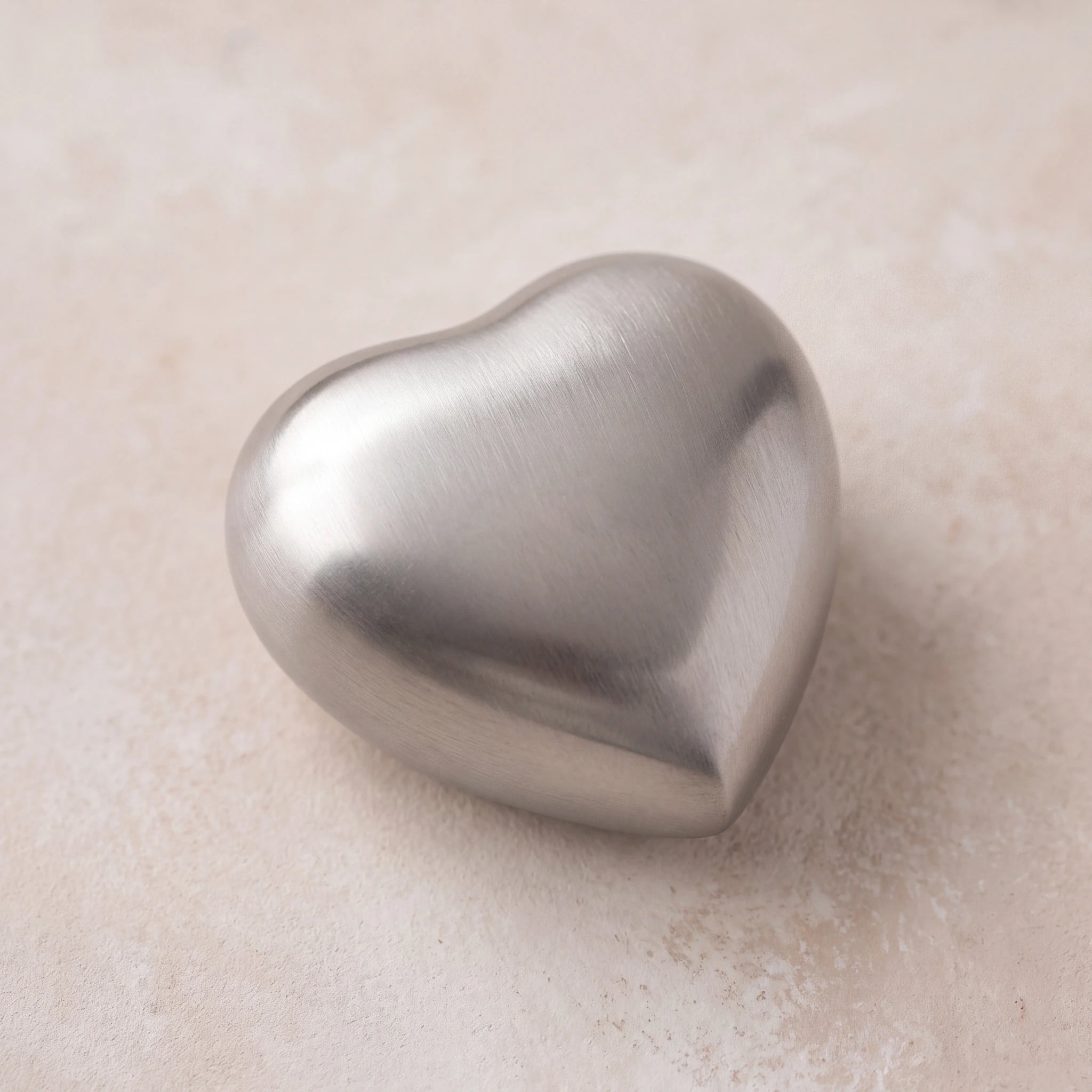Brushed-Metal-Heart-Keepsake-Urn-for-Ashes-in-Silver-heart_plaster_above