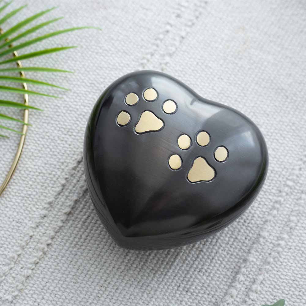 Brushed Metal Heart Keepsake Urn for Ashes with Paw Print Motif 60ml on Table in Home