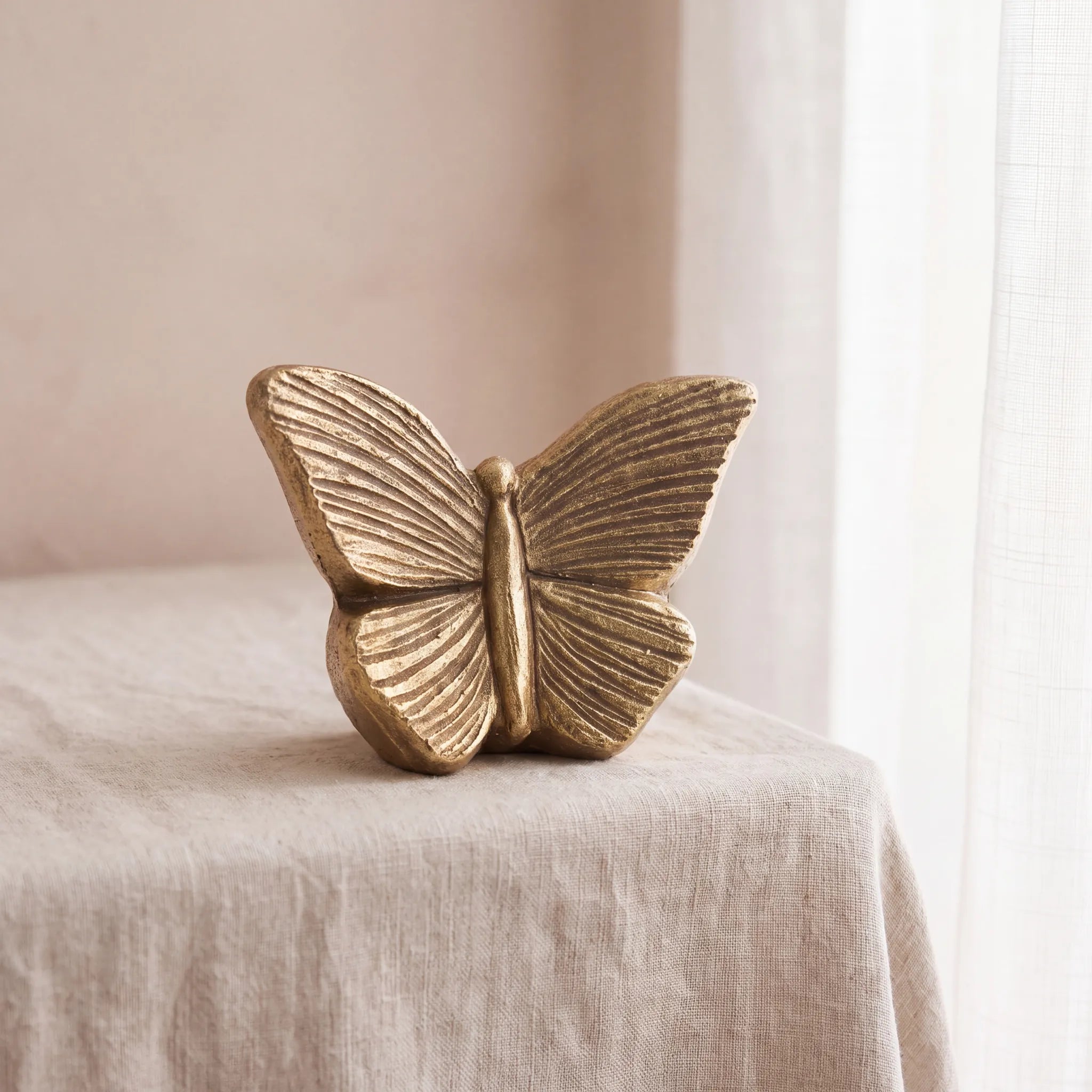 Butterfly-Keepsake-Urn-for-Ashes-in-Gold-Linen-Table