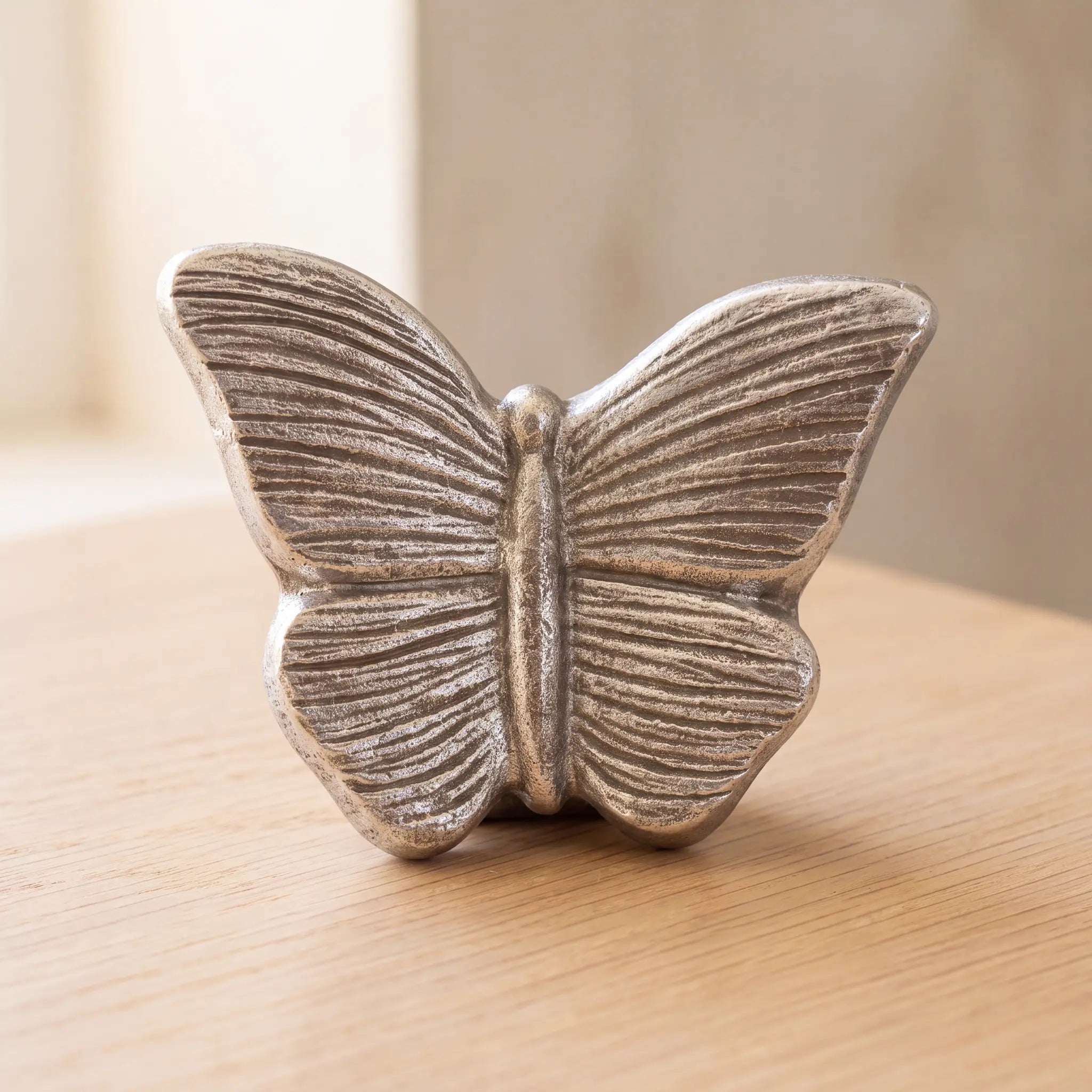 Butterfly-Keepsake-Urn-for-Ashes-in-Silver-On-Oak