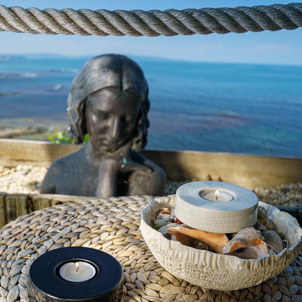 Caleo Keepsake Candle in Black Outside on Table