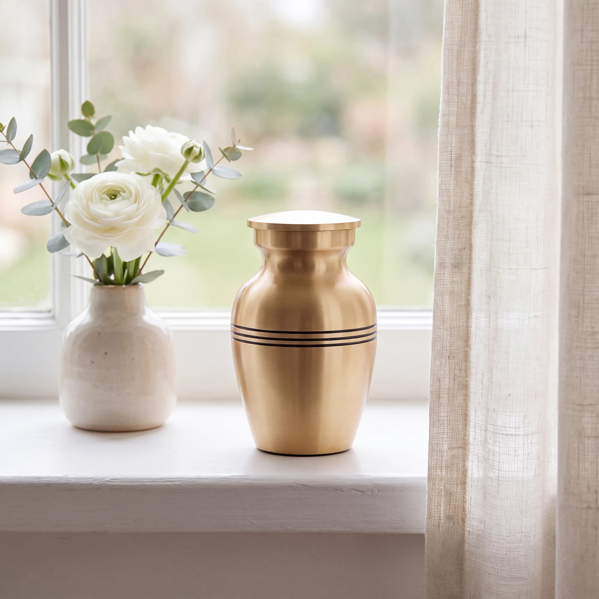 Classic-Metal-Keepsake-Urn-for-Ashes-in-Brushed-Gold-keepsake_windowsill_posy