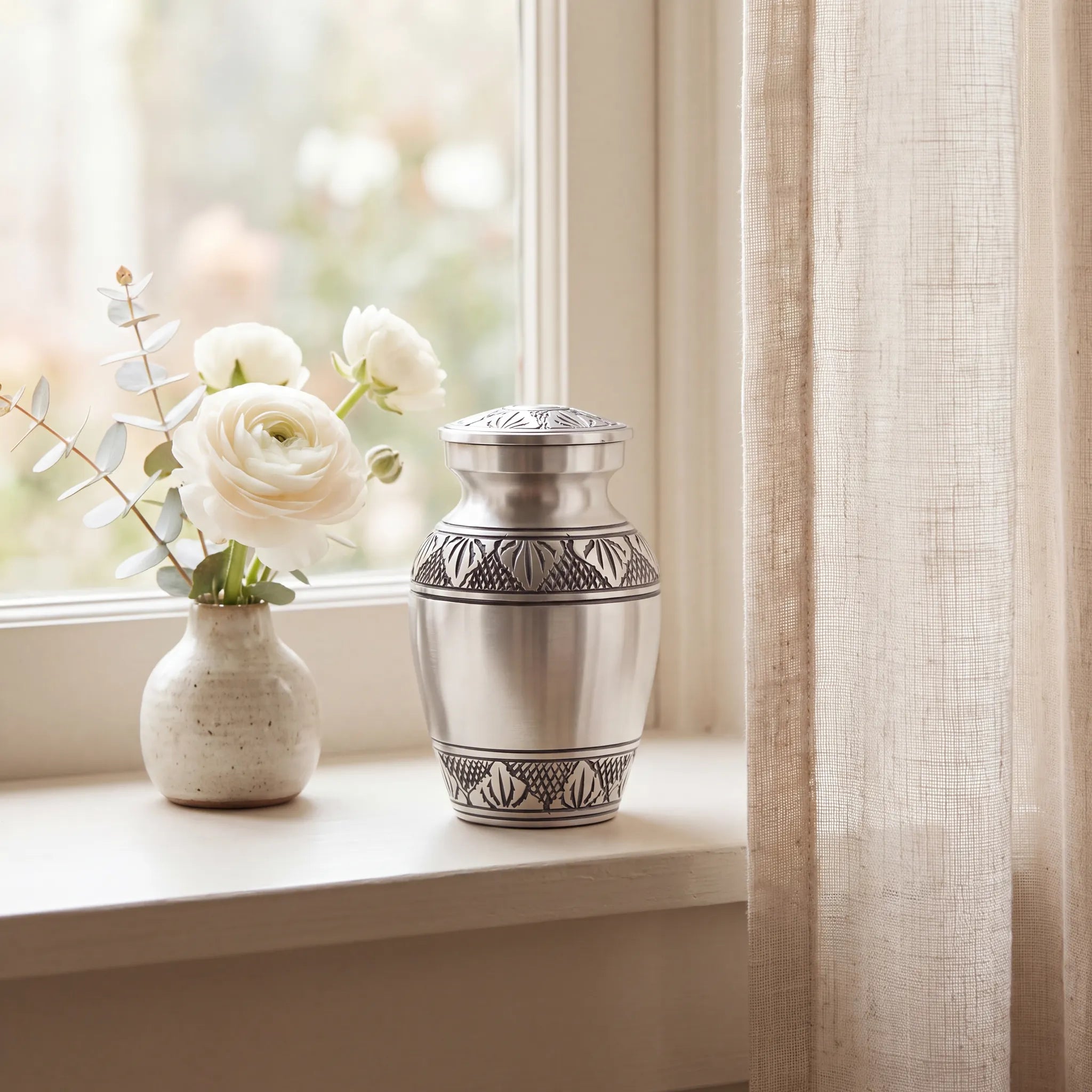 Classic-Metal-Keepsake-Urn-for-Ashes-in-Brushed-Silver-keepsake_windowsill_posy