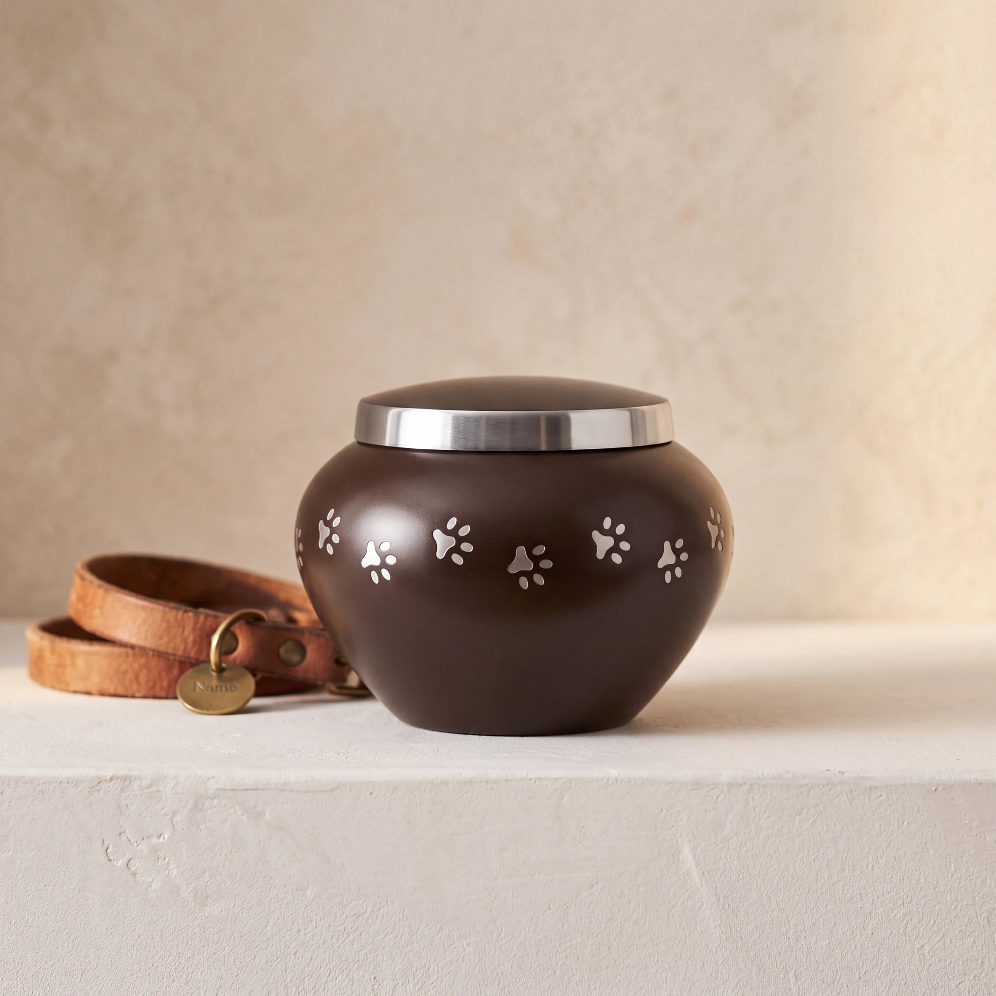 Classic-Pawprints-Pet-Urn-for-Ashes-in-Dark-Brown-Silver-Small-pet_collar_ledge