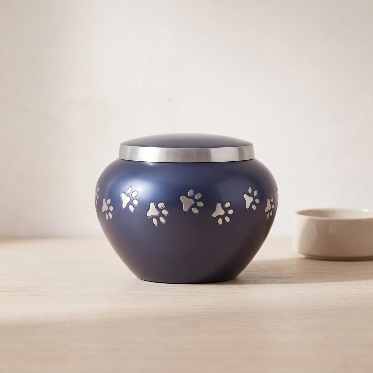 Classic-Pawprints-Pet-Urn-for-Ashes-in-Midnight-Blue-Silver-Medium-pet_bowl_ledge