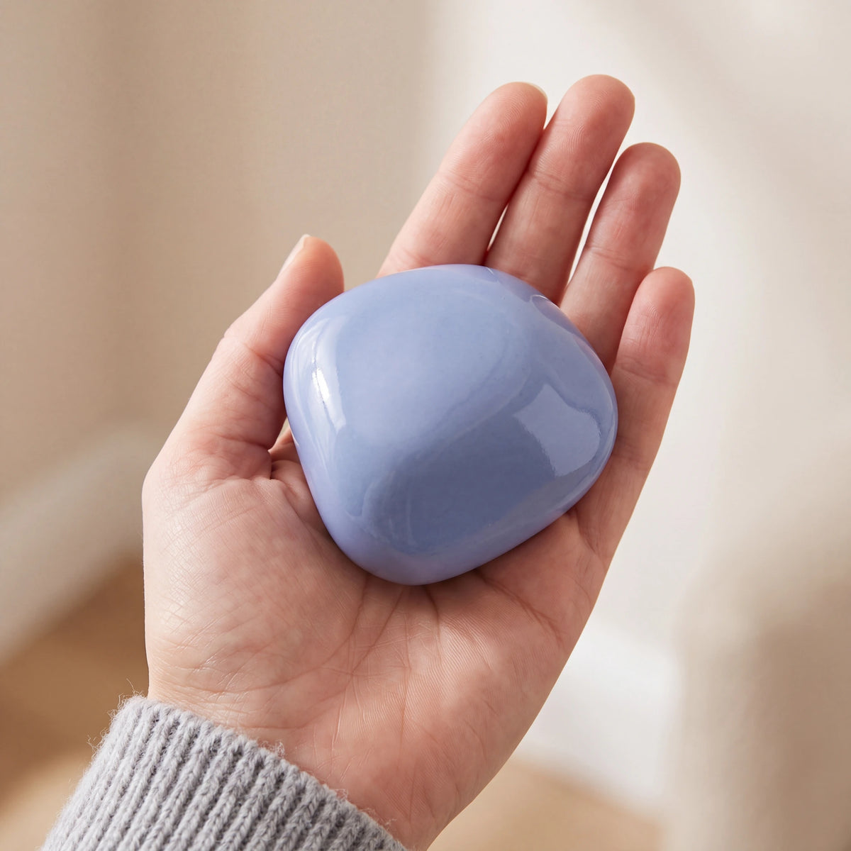 Cuddle-Stone-Keepsake-Urn-for-Ashes-in-Light-Blue-Held-in-Palm
