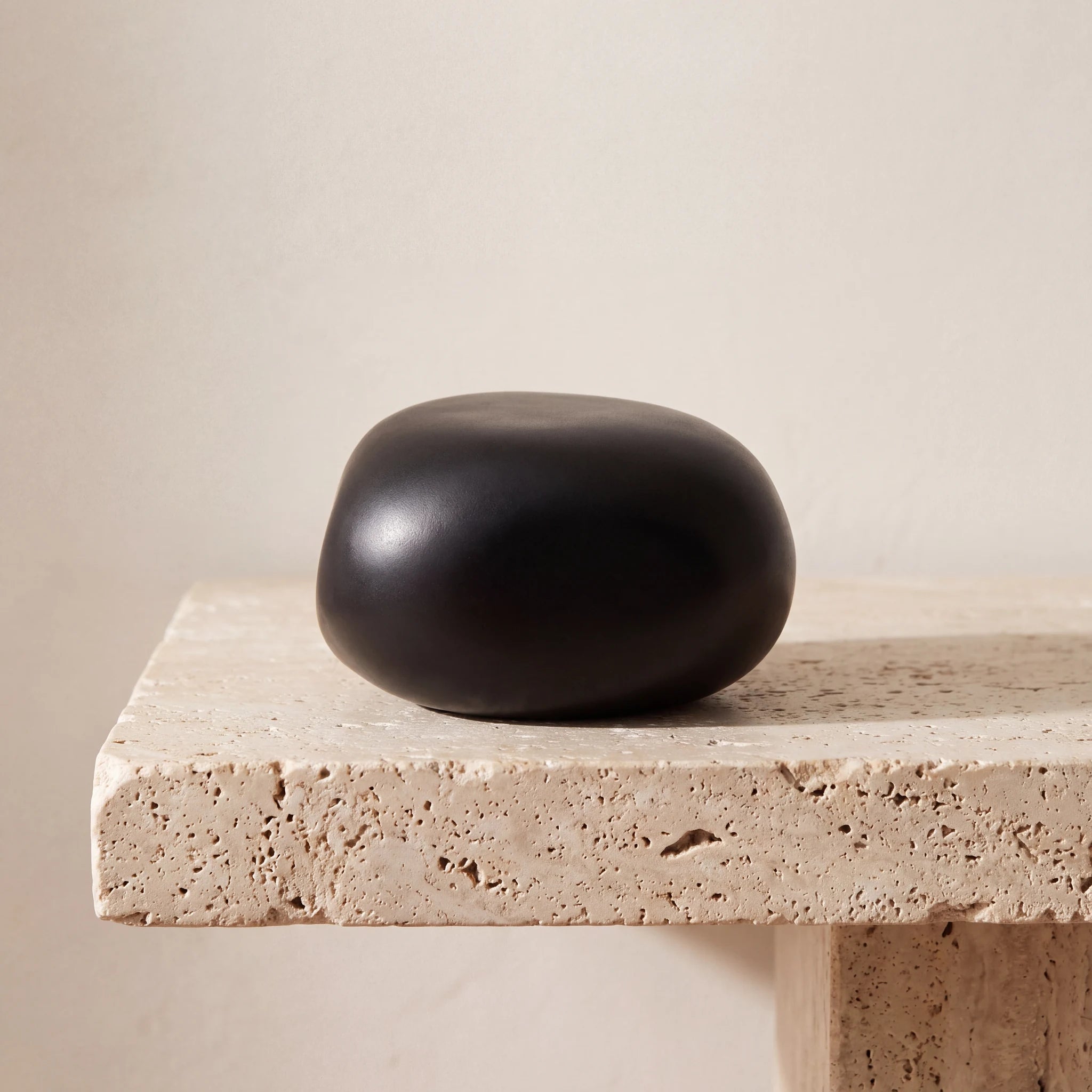 Cuddle-Stone-Keepsake-Urn-for-Ashes-in-Matte-Black-Travertine-Ledge