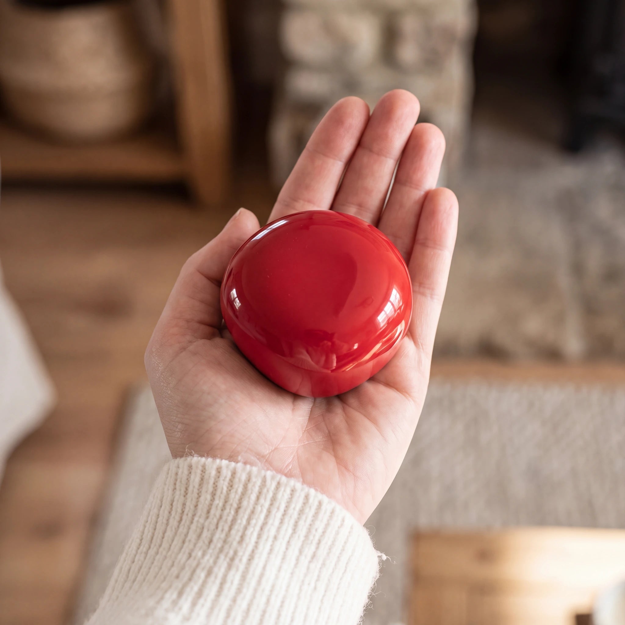 Cuddle-Stone-Keepsake-Urn-for-Ashes-in-Red-Held-in-Palm