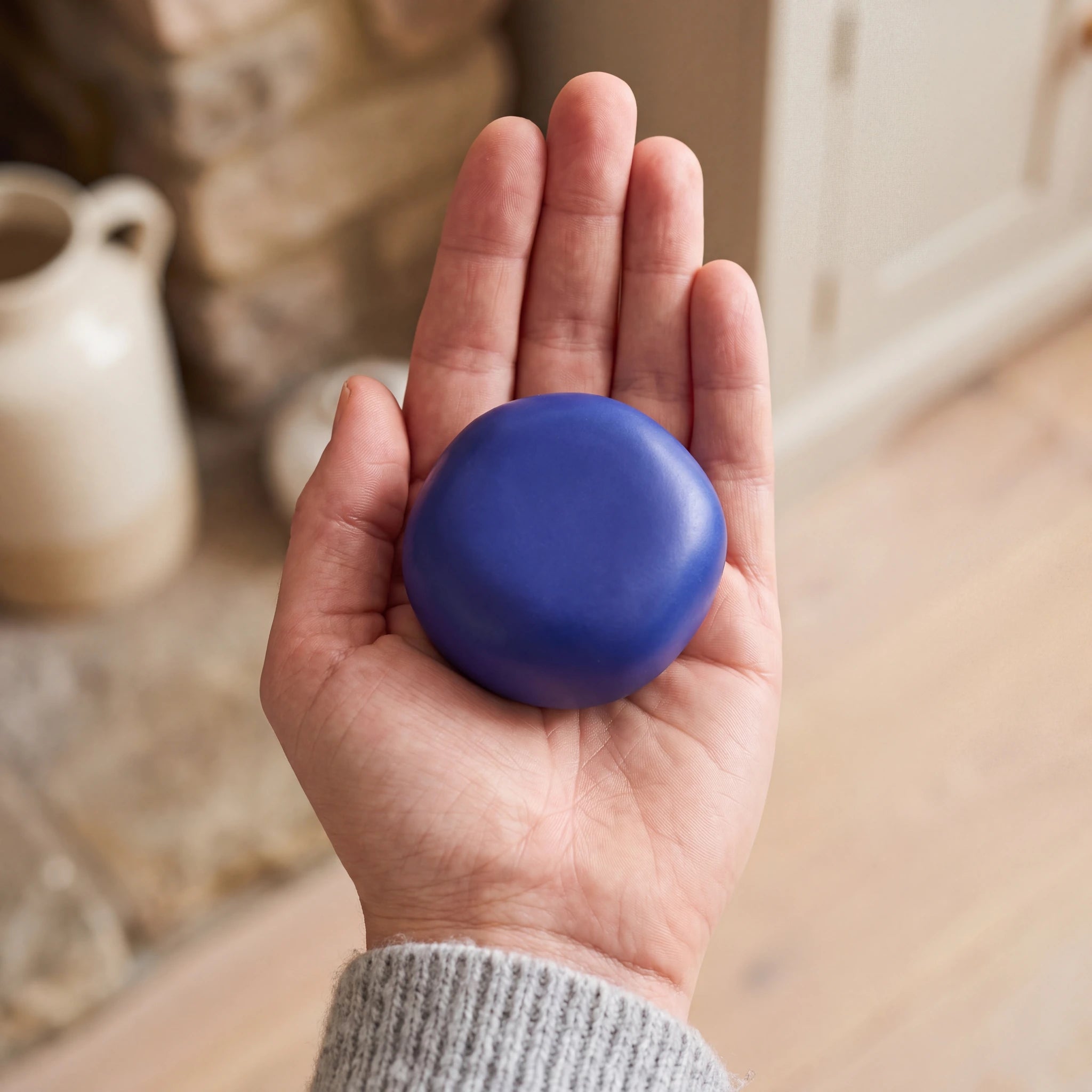 Cuddle-Stone-Keepsake-Urn-for-Ashes-in-Royal-Blue-Held-in-Palm
