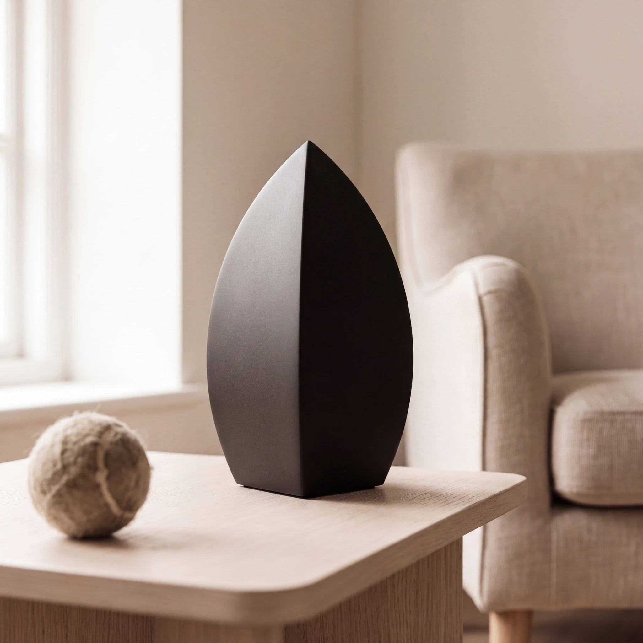 Drop-Pet-Urn-for-Ashes-in-Matte-Black-Stainless-Steel-pet_reading_nook