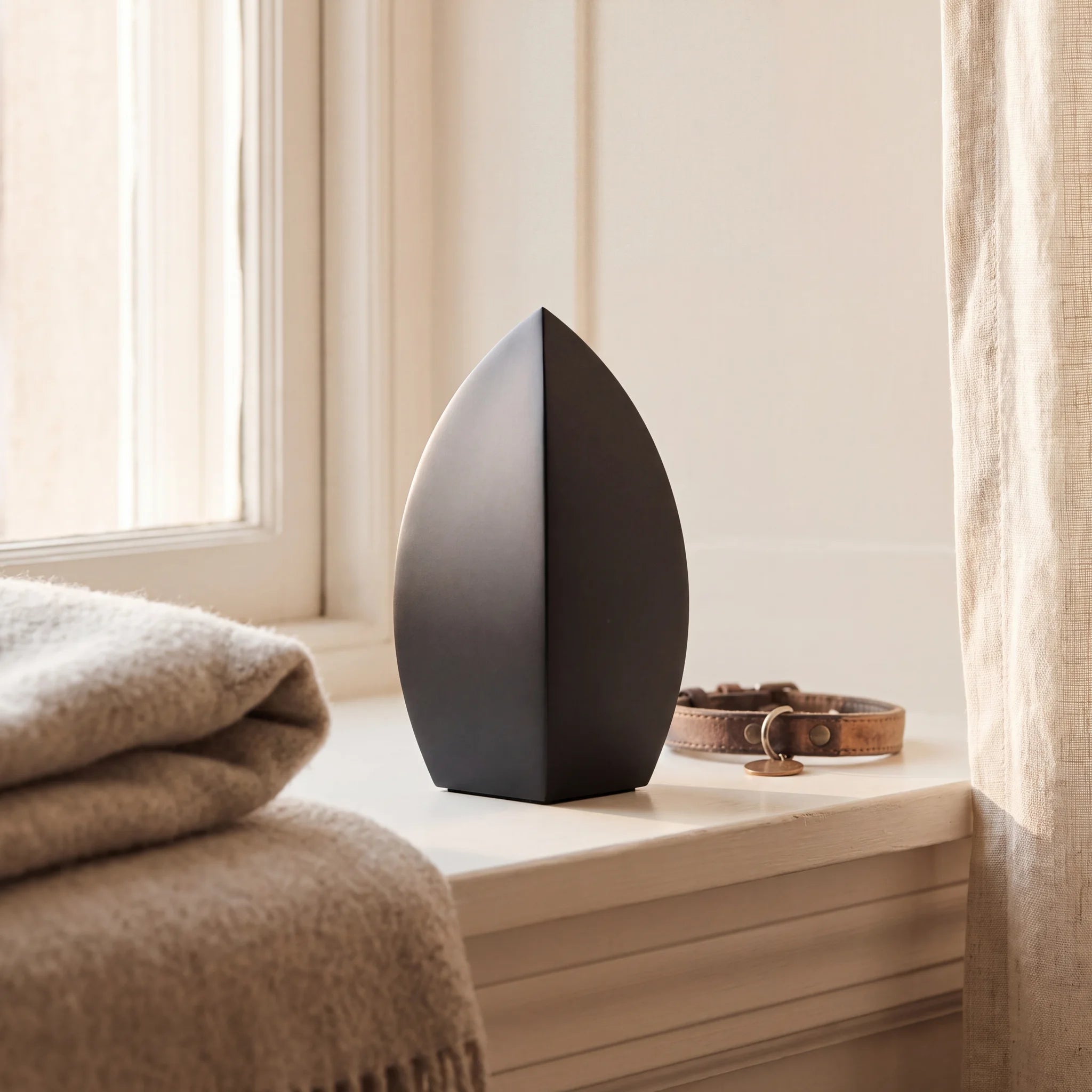 Drop-Pet-Urn-for-Ashes-in-Matte-Black-Stainless-Steel-pet_sunny_sill