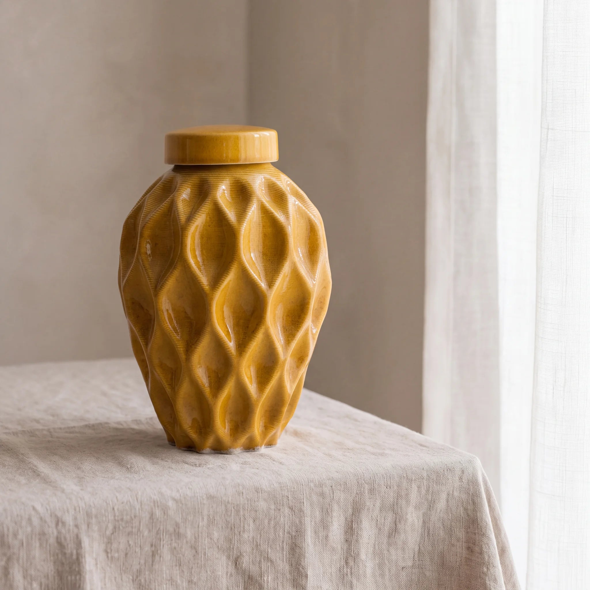 Echo-Medium-Urn-for-Ashes-in-Amber-Yellow-Linen-Table