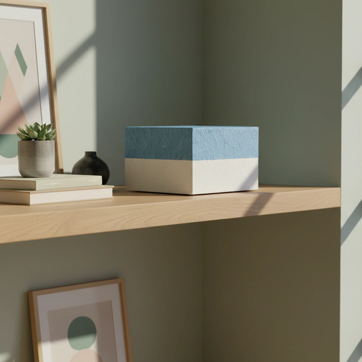 Embrace Biodegradable Urn for Ashes in Blue Medium On Shelf Side View Daylight