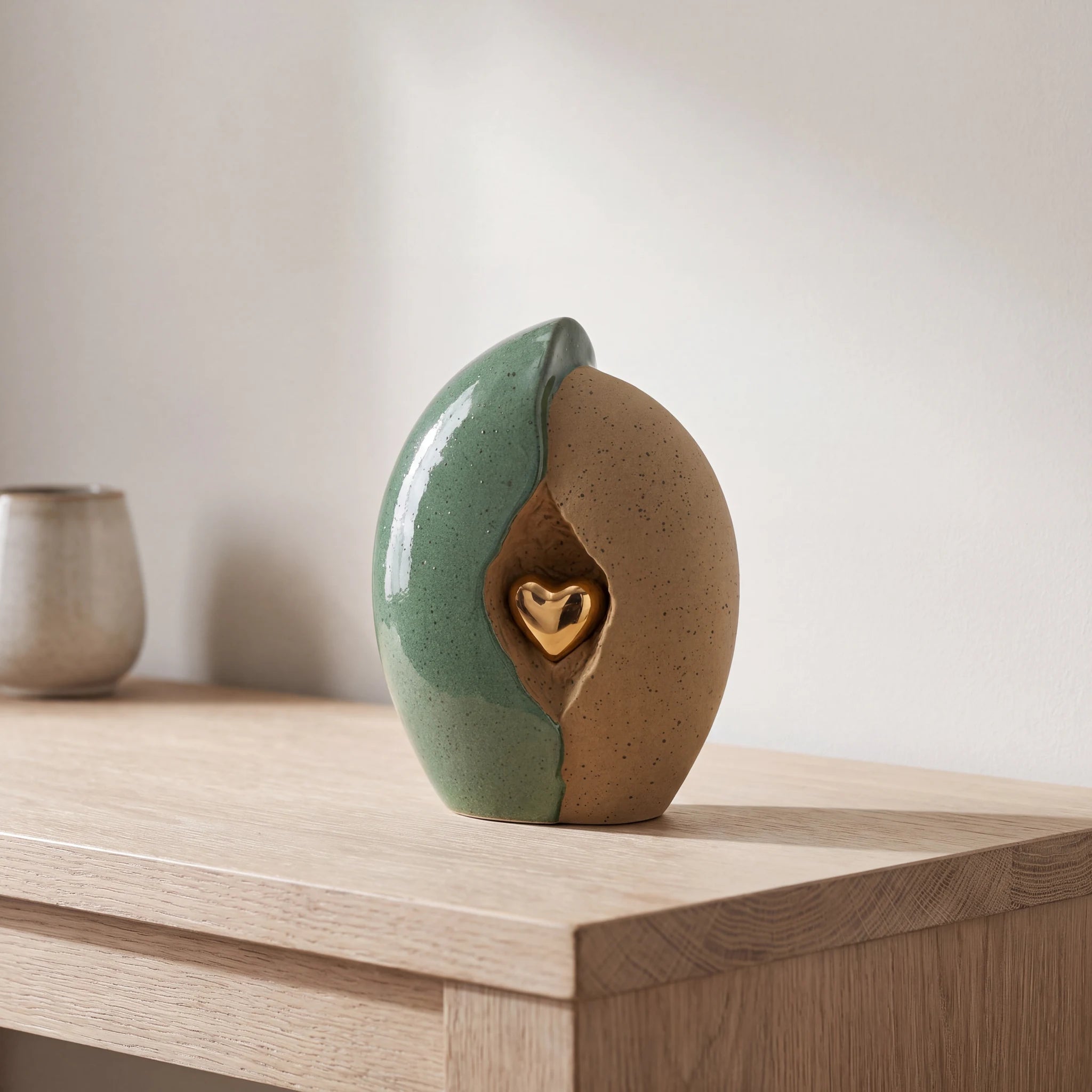 Embrace-Heart-Medium-Urn-for-Ashes-in-Fern-Green-and-Sand-Oak-Console
