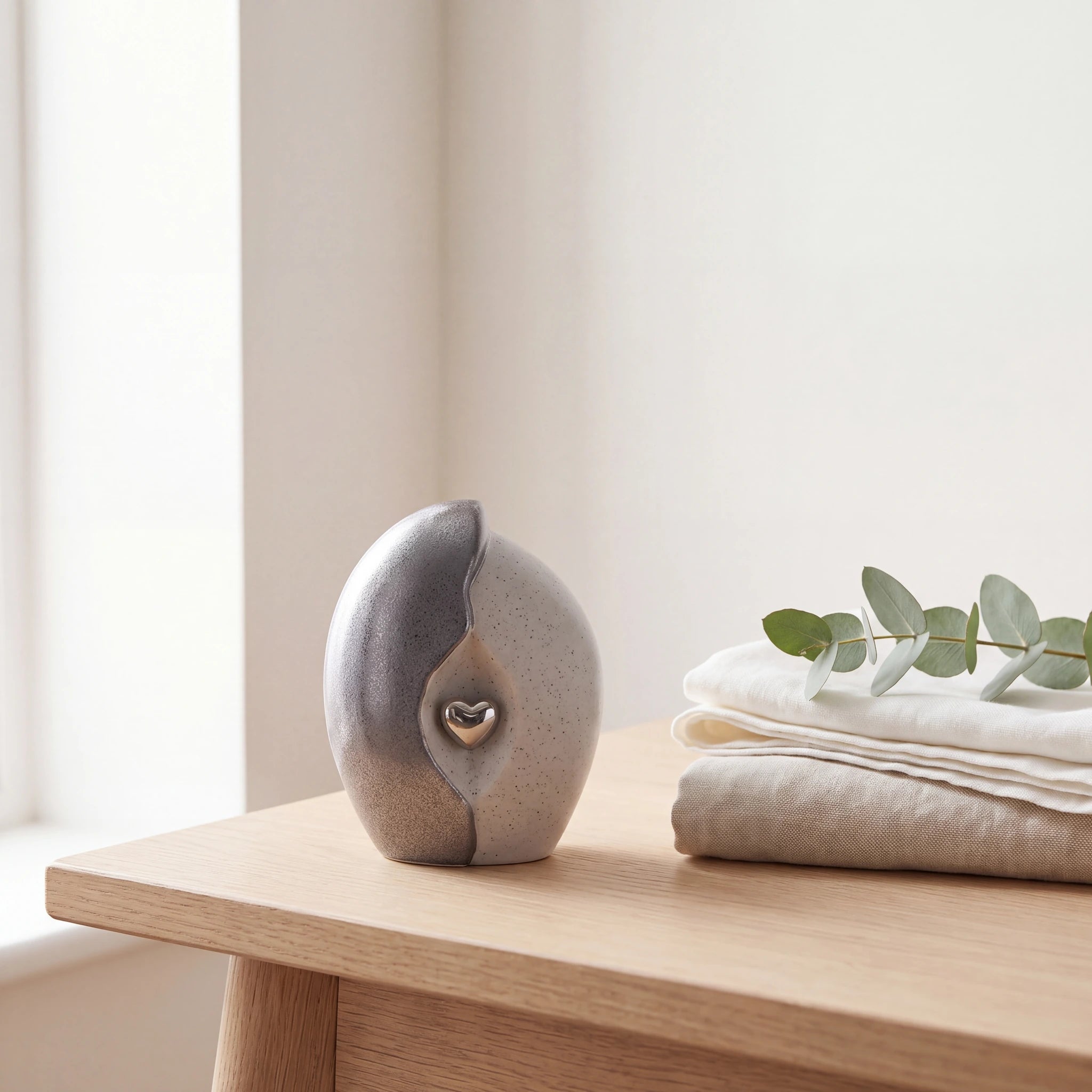 Embrace-Heart-Small-Urn-for-Ashes-in-Grey-and-Silver-Folded-Linen