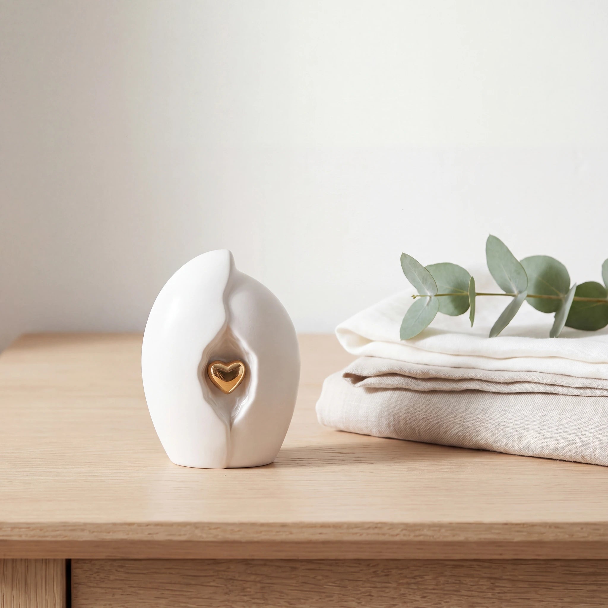 Embrace-Heart-Small-Urn-for-Ashes-in-White-and-Gold-Folded-Linen