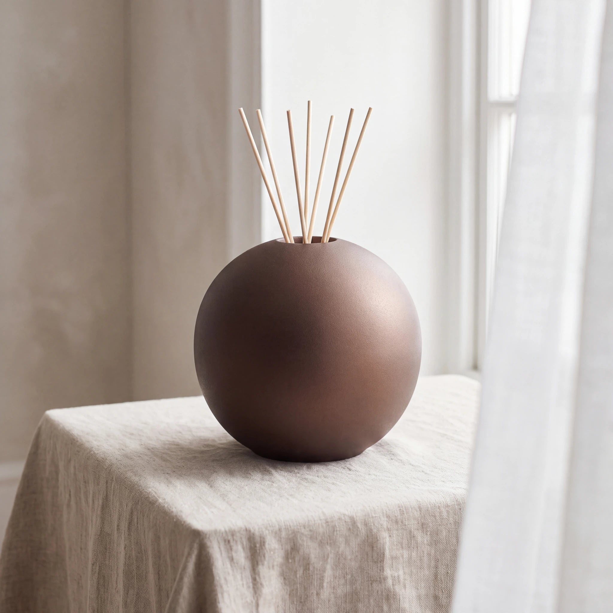 Essence-of-Life-Scented-Medium-Urn-for-Ashes-in-Bronze-Linen-Table