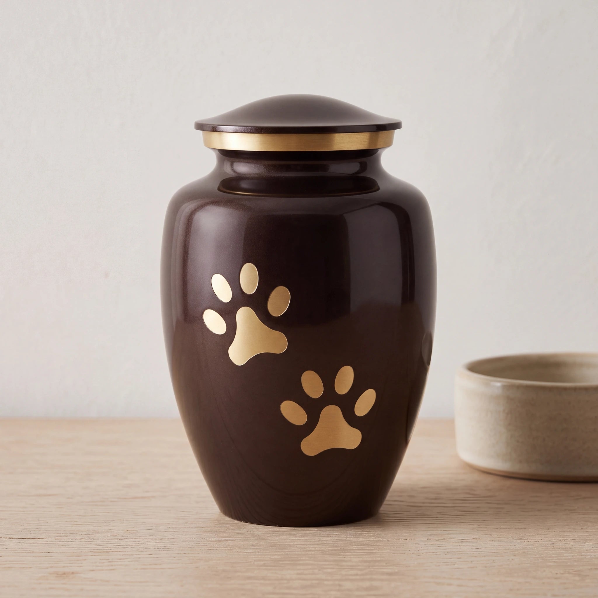 Golden-Pawprints-Pet-Urn-for-Ashes-in-Dark-Brown-Gold-Large-pet_bowl_ledge