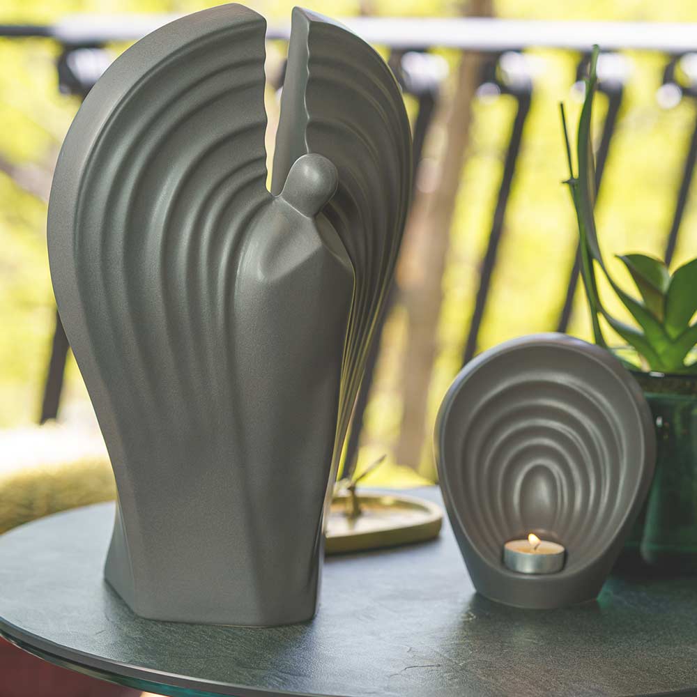 Guardian Angel Small Urn for Ashes in Matte Grey On Table Outside Light