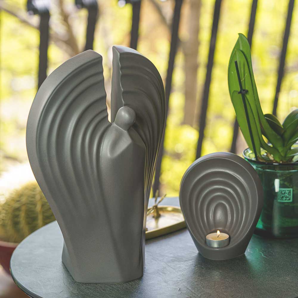 Guardian Angel Small Urn for Ashes in Matte Grey On Table Outside