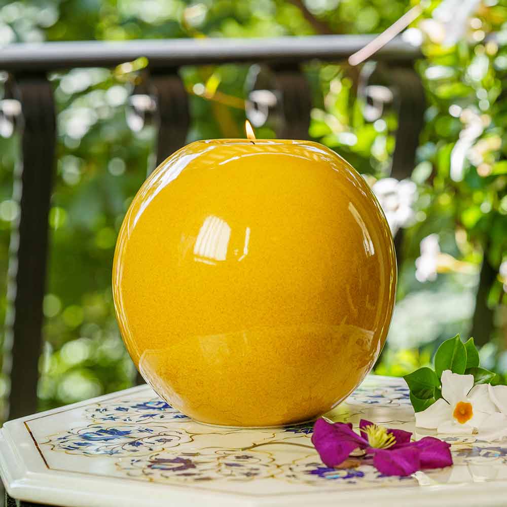 Harmony Adult Cremation Urn for Ashes in Amber Yellow Outside in Daylight