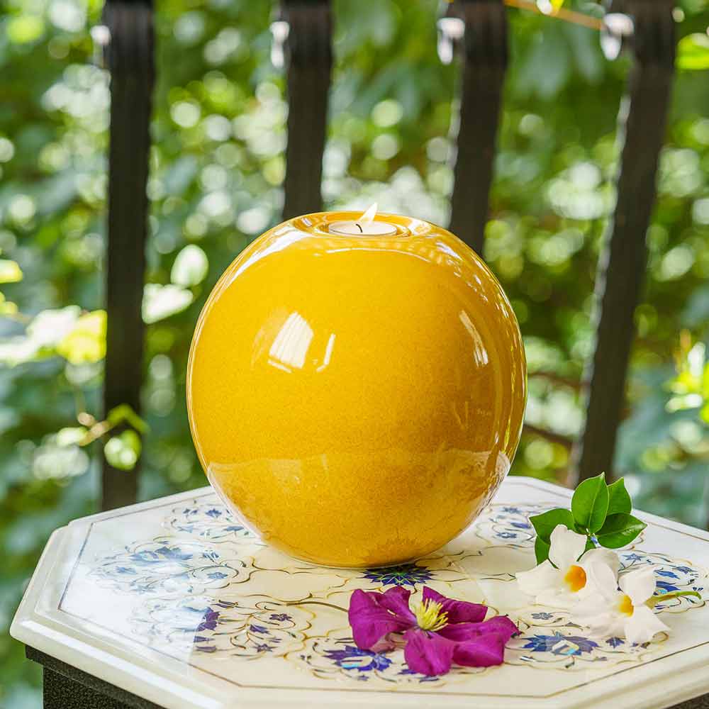 Harmony Adult Cremation Urn for Ashes in Amber Yellow Outside onTable