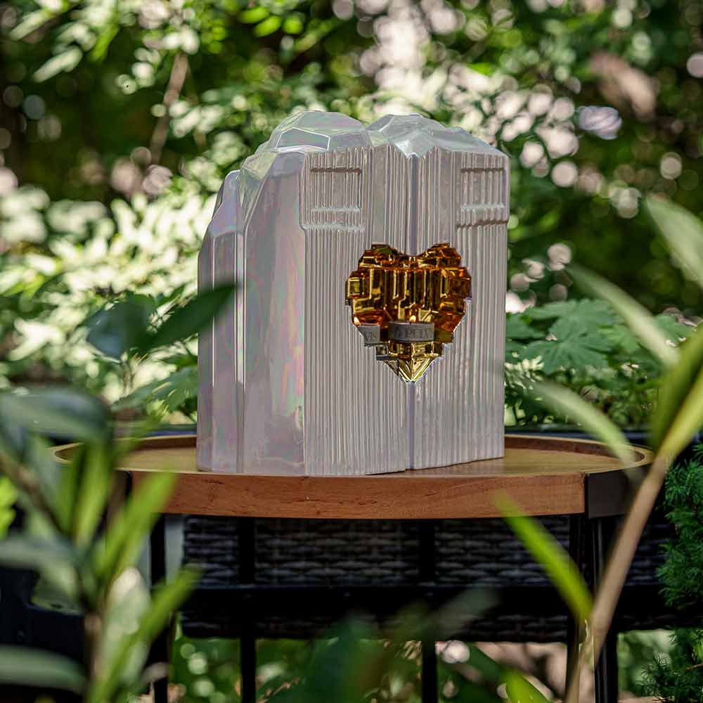 Heart Companion Urns for Two Adults in Pearlescent White and Gold Together On Table Outside