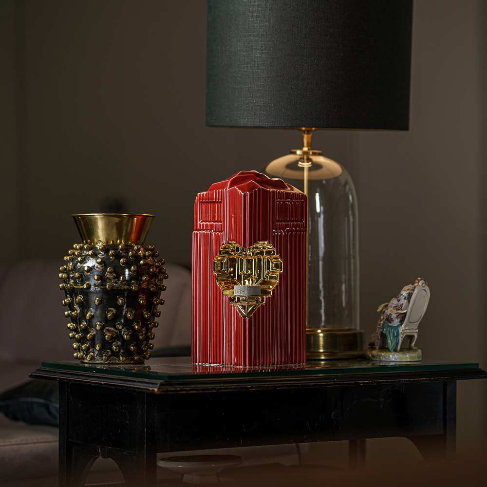 Heart Cremation Urn for Ashes Red and Gold Inside on Table