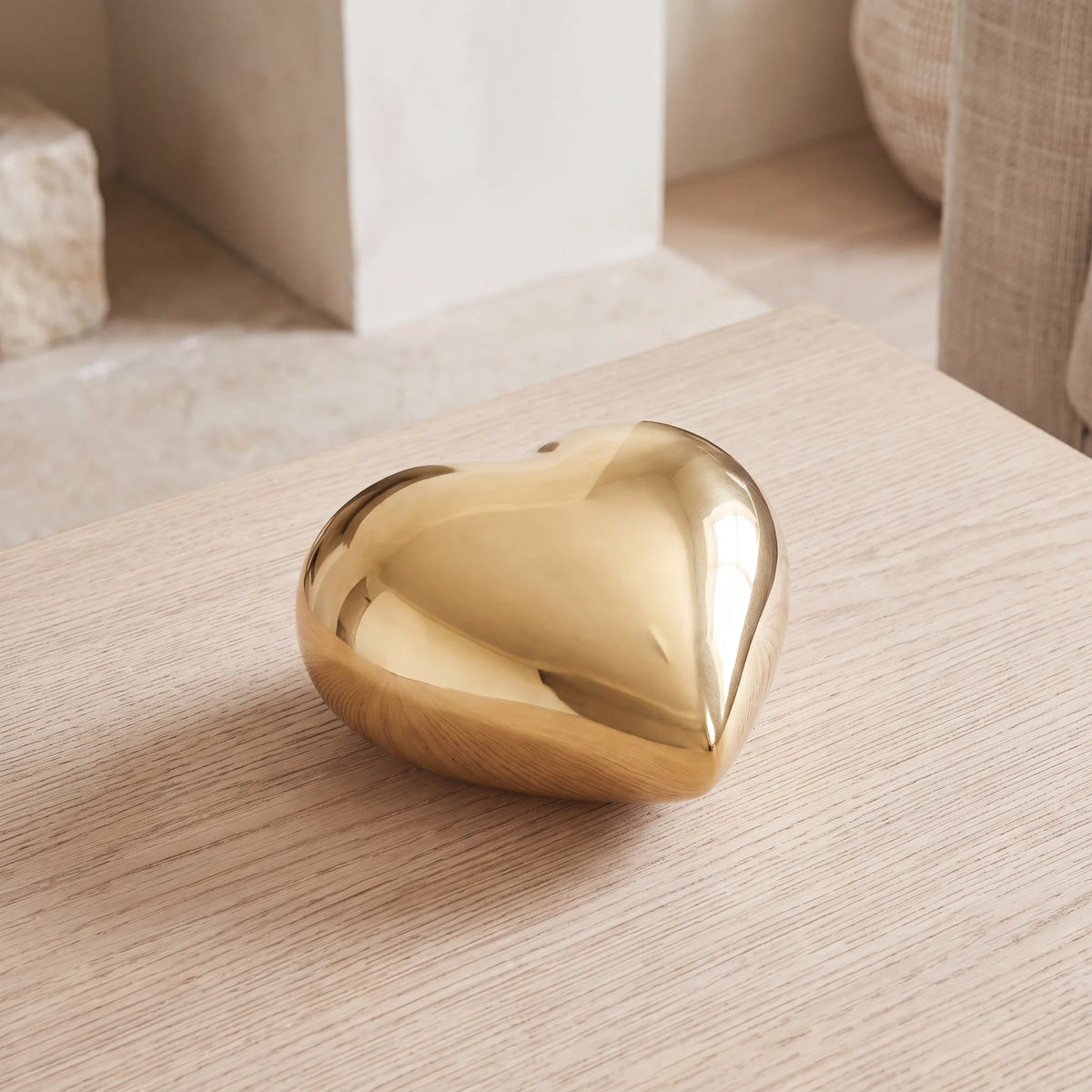 Heart-Keepsake-Urn-for-Ashes-in-Glossy-Gold-Metal-On-Oak