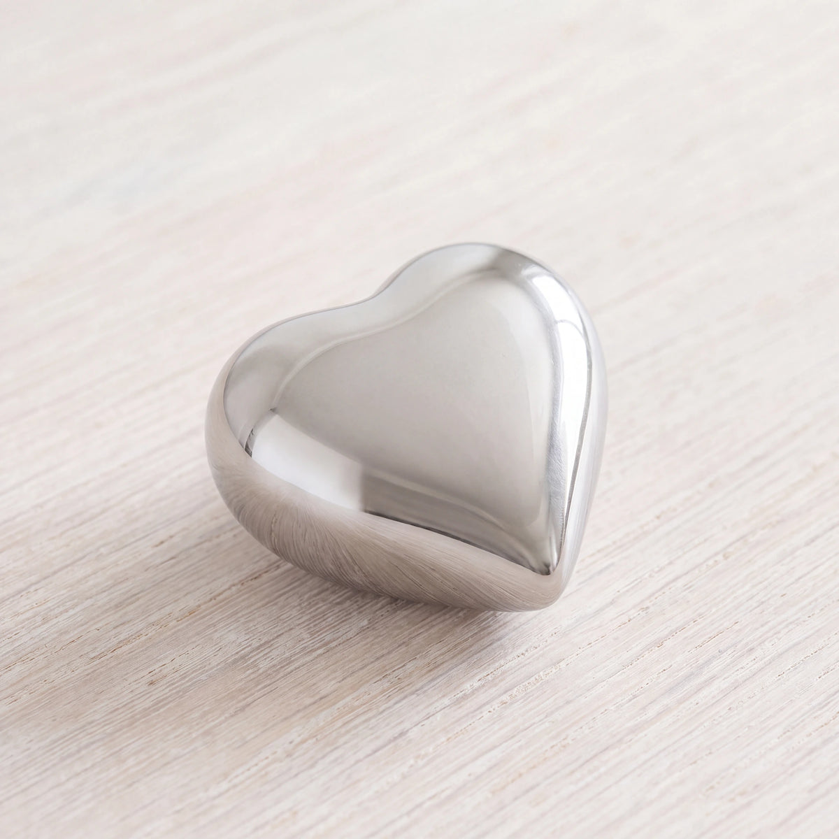 Heart-Keepsake-Urn-for-Ashes-in-Glossy-Silver-Metal-heart_limewash_above