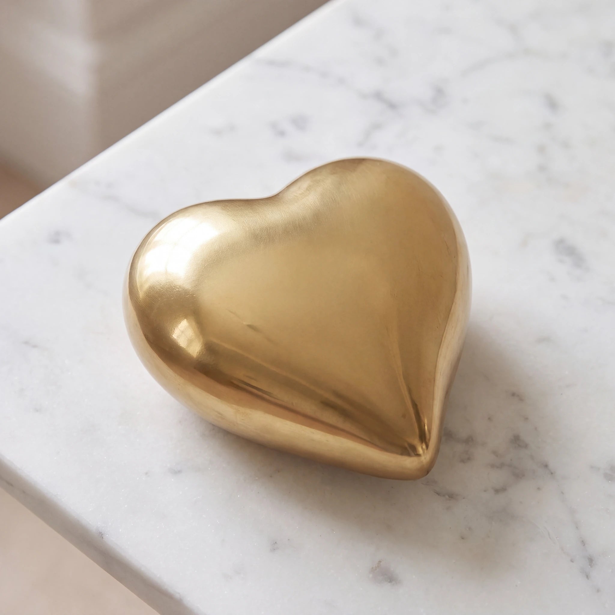 Heart-Keepsake-Urn-for-Ashes-in-Gold-On-Marble