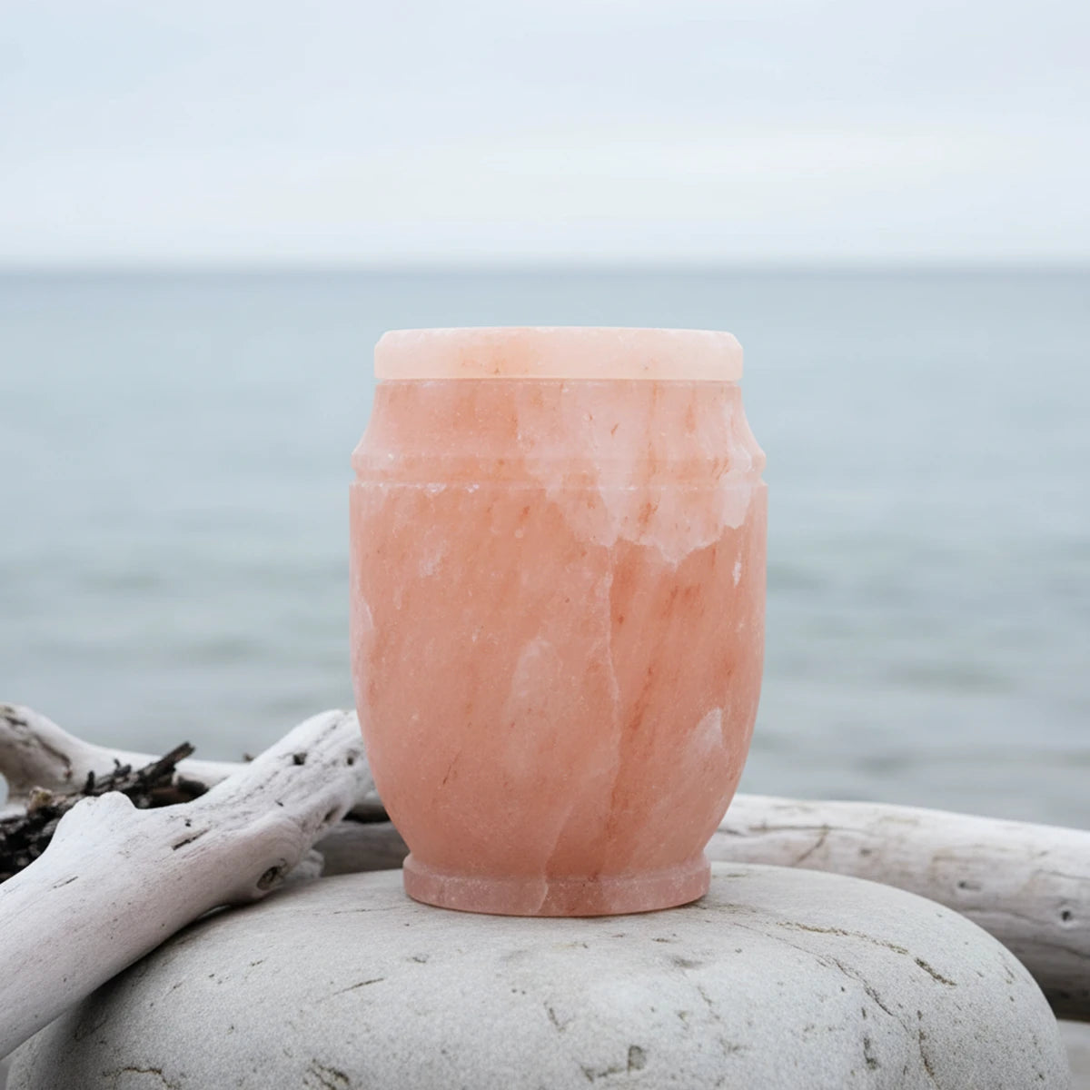 Himalayan Rock Salt Biodegradable Water Urn for Ashes by Shore in Daylight