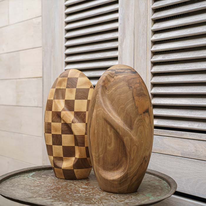 Infinity Wooden Adult Urn for Ashes Chequered and Walnut on Table by a Wall