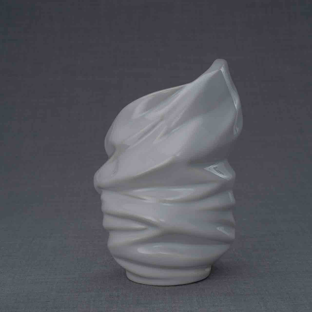 Light Ashes Keepsake Urn in White Behind Dark Background