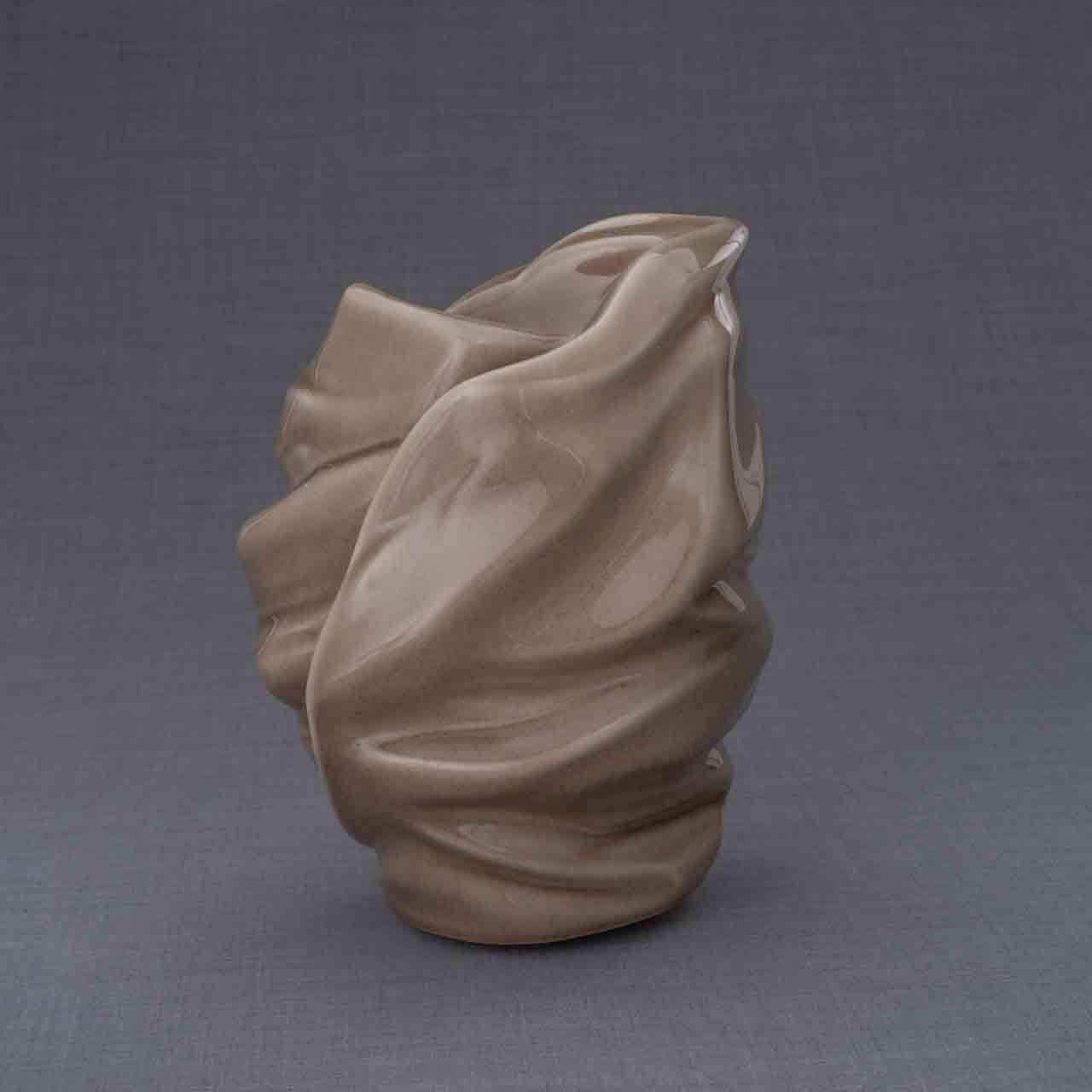 Light Cremation Urn for Ashes in Dark Beige Behind Dark Background