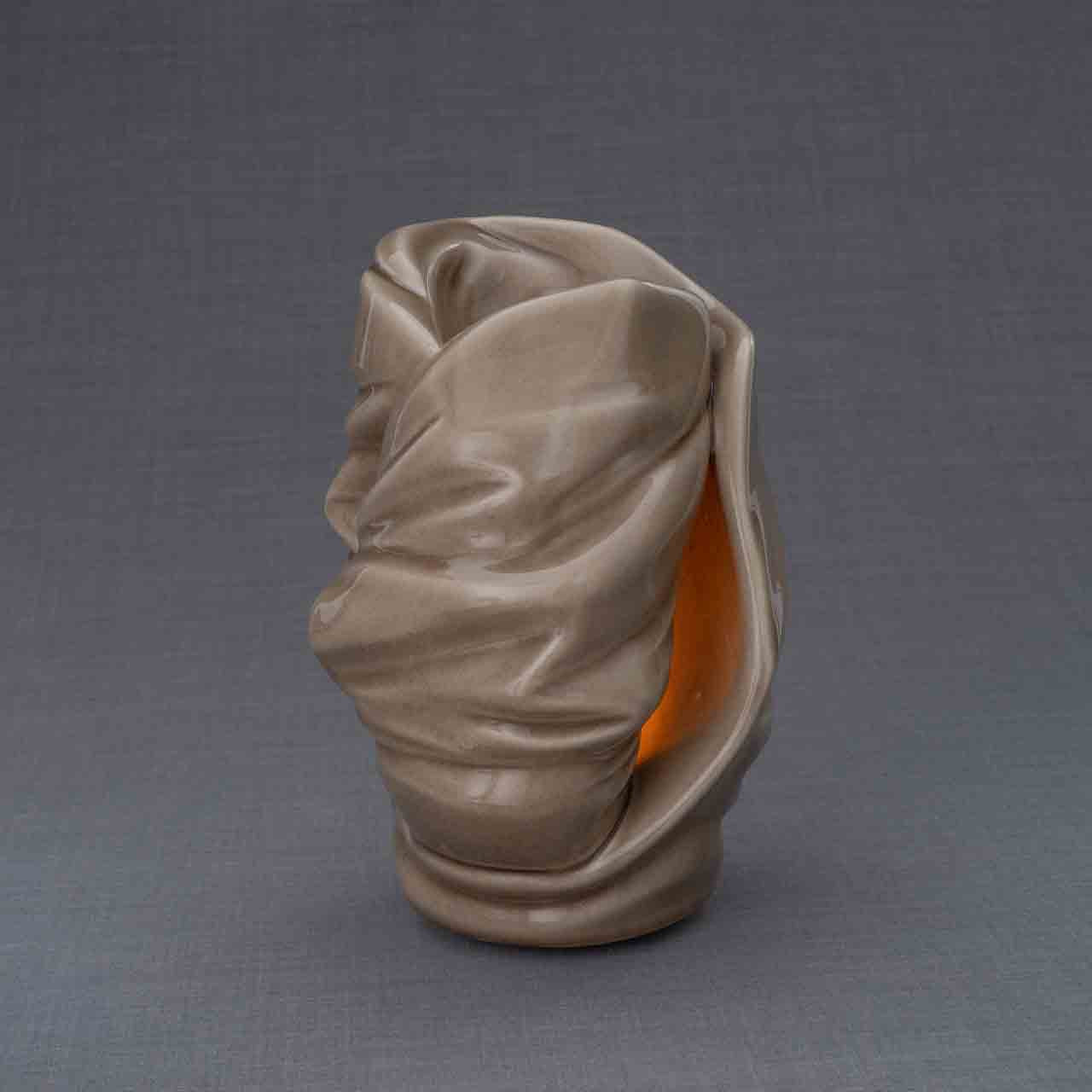 Light Cremation Urn for Ashes in Dark Beige Turned To The Side Dark Background