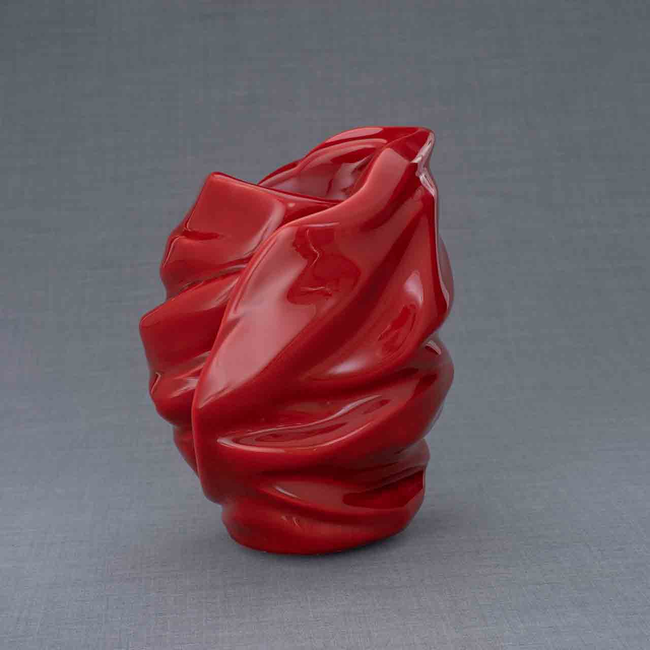 Light Cremation Urn for Ashes in Red Behind Grey Background