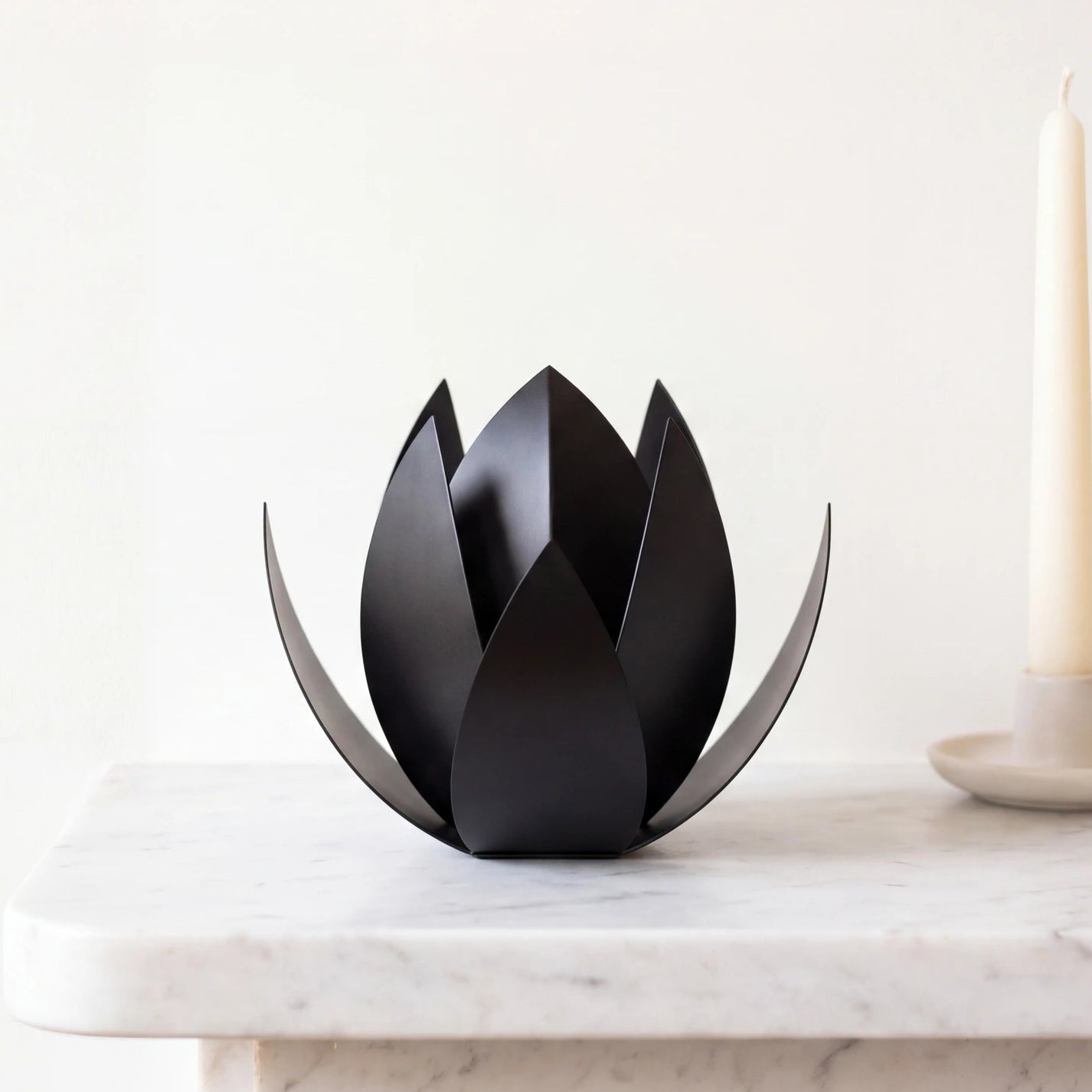 Lotus-Extra-Small-Urn-for-Ashes-in-Matte-Black-Stainless-Steel-Marble-Ledge