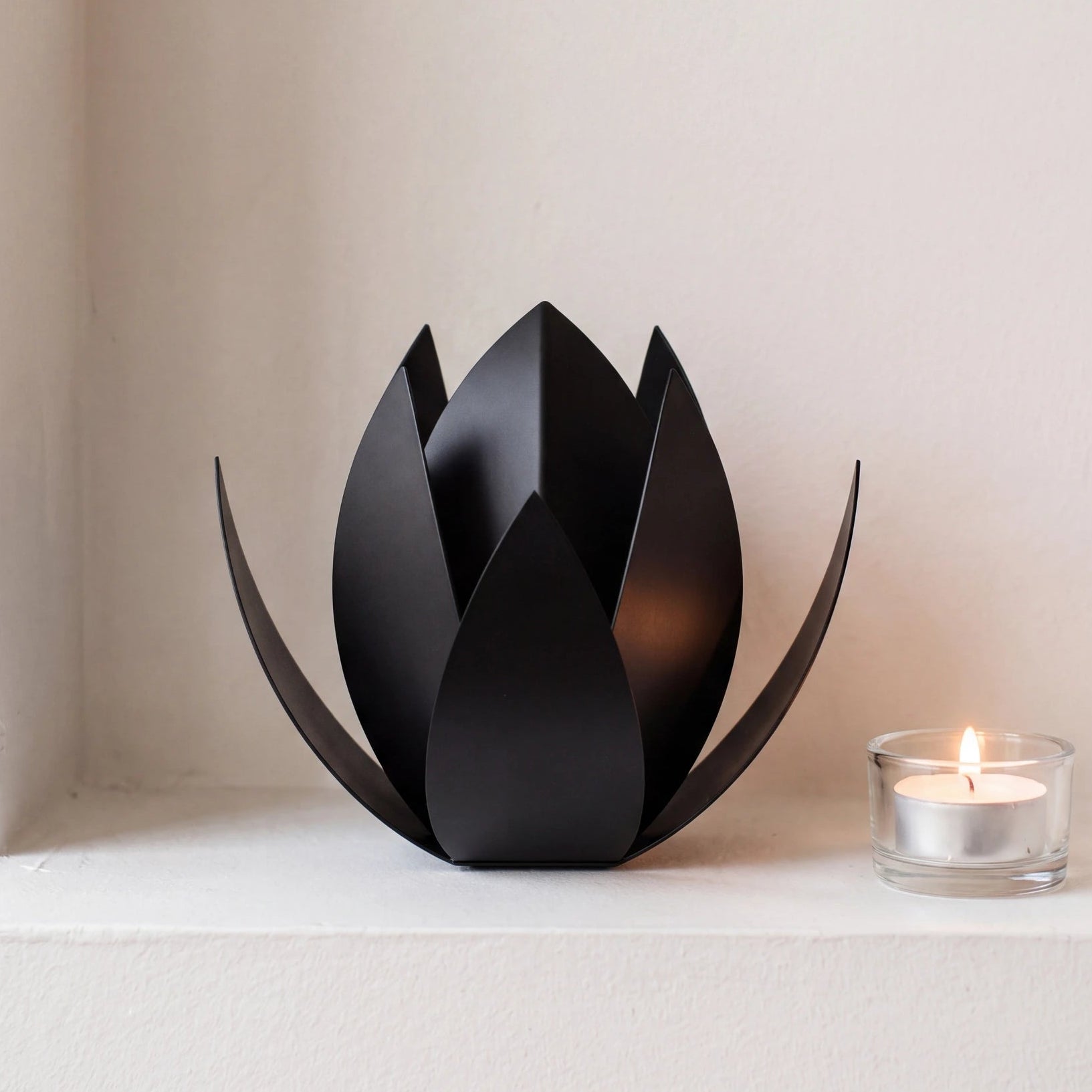 Lotus-Small-Urn-for-Ashes-in-Matte-Black-Stainless-Steel-keepsake_tealight_ledge