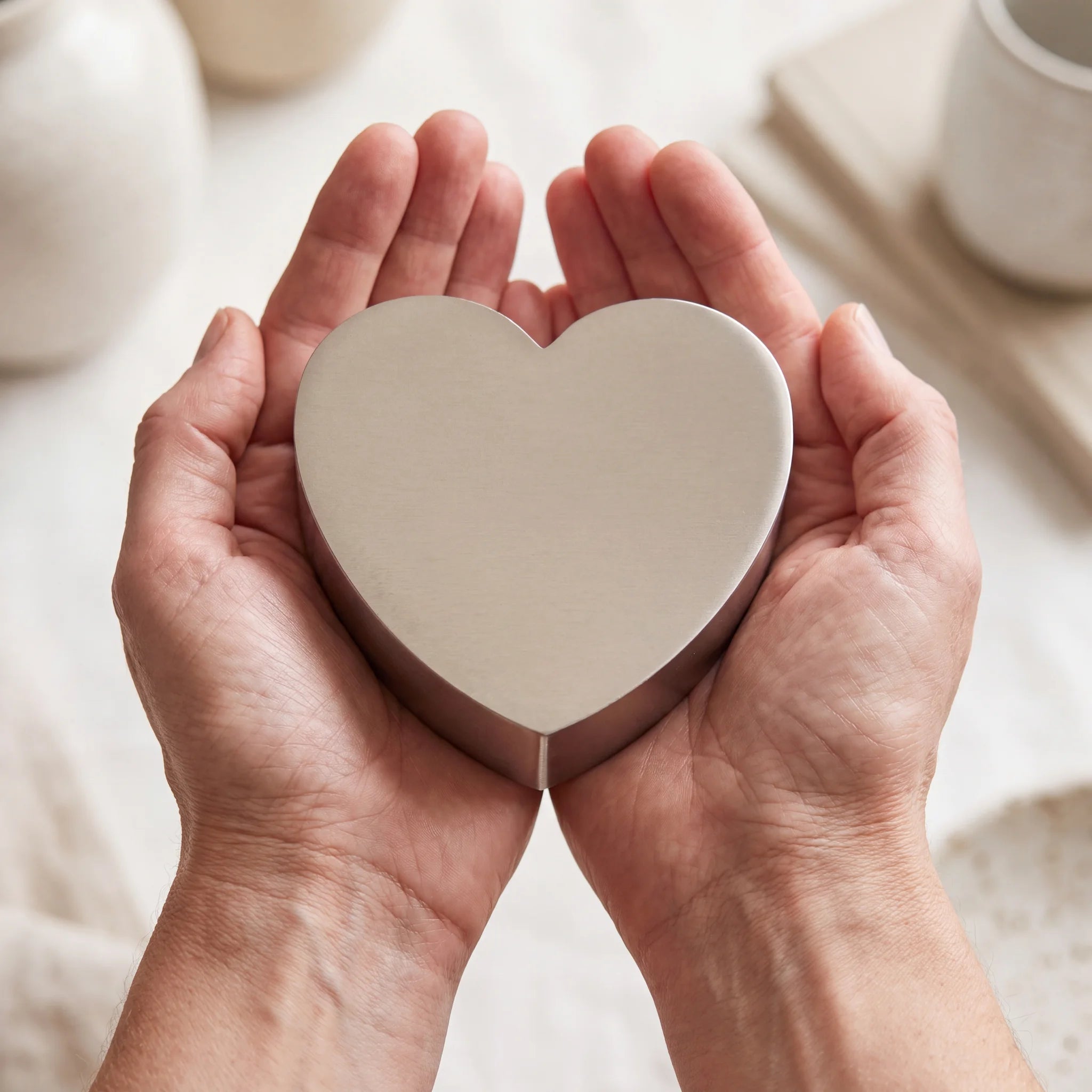 Love-Heart-Extra-Small-Urn-for-Ashes-in-Stainless-Steel-Cupped-in-Hands