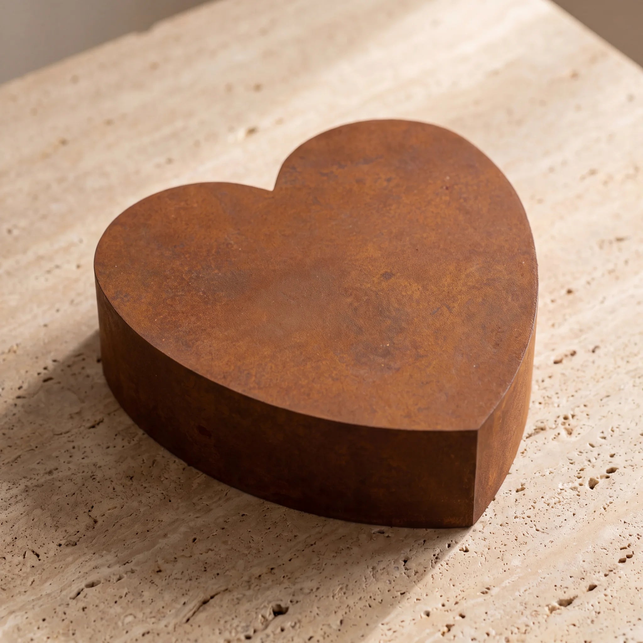 Love-Heart-Large-Urn-for-Ashes-in-Corten-Steel-On-Travertine