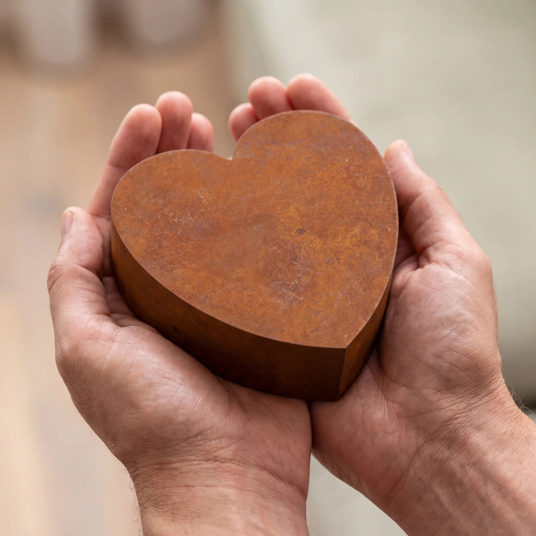 Love-Heart-Small-Urn-for-Ashes-in-Corten-Steel-Cupped-in-Hands