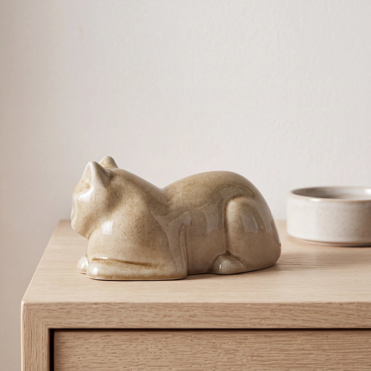 Lying-Cat-Mini-Urn-for-Ashes-in-Dark-Sand-pet_bowl_ledge