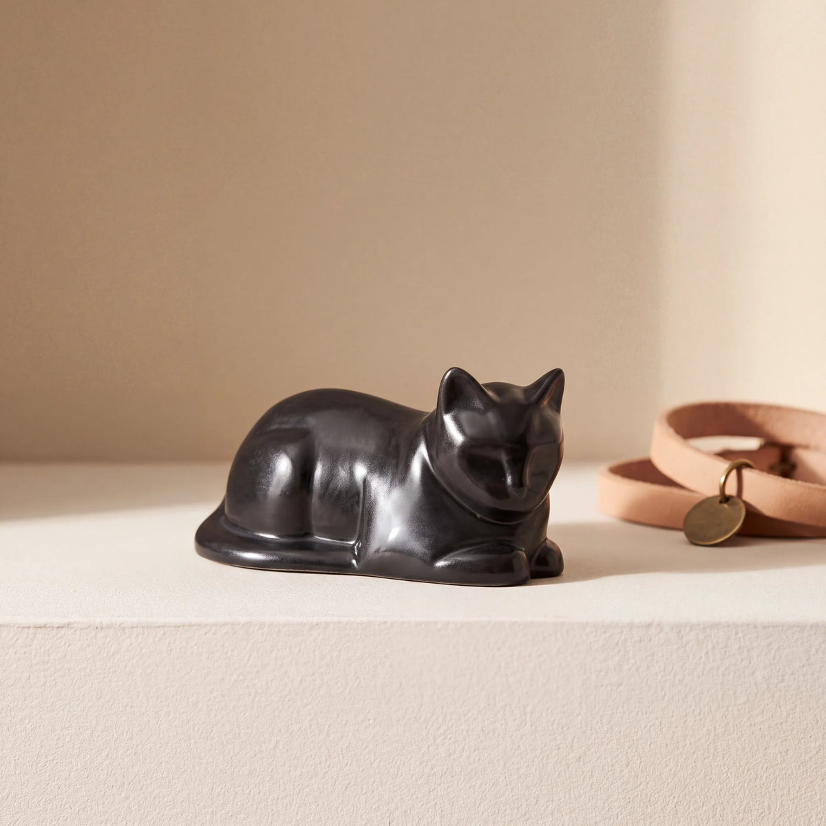 Lying-Cat-Mini-Urn-for-Ashes-in-Matte-Black-pet_collar_ledge