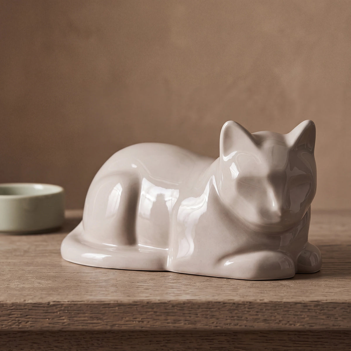 Lying-Cat-Urn-for-Ashes-in-Cream-pet_bowl_ledge