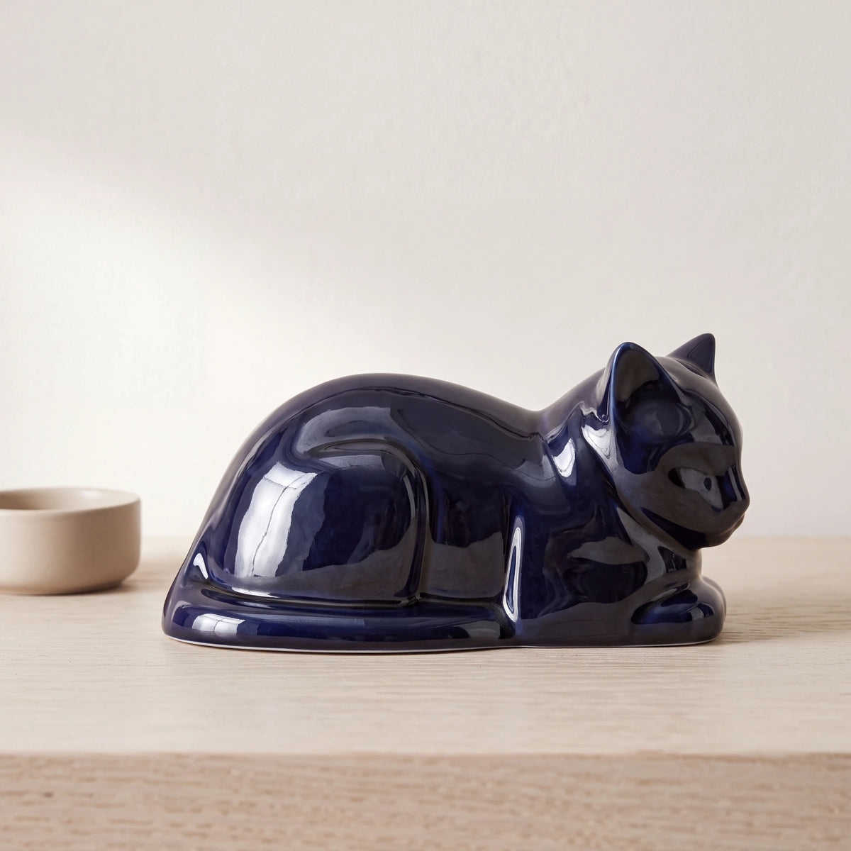 Lying-Cat-Urn-for-Ashes-in-Metallic-Blue-pet_bowl_ledge