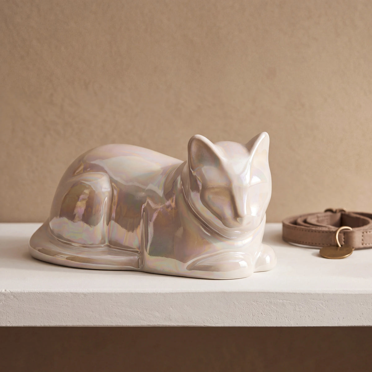Lying-Cat-Urn-for-Ashes-in-Pearlescent-White-pet_collar_ledge