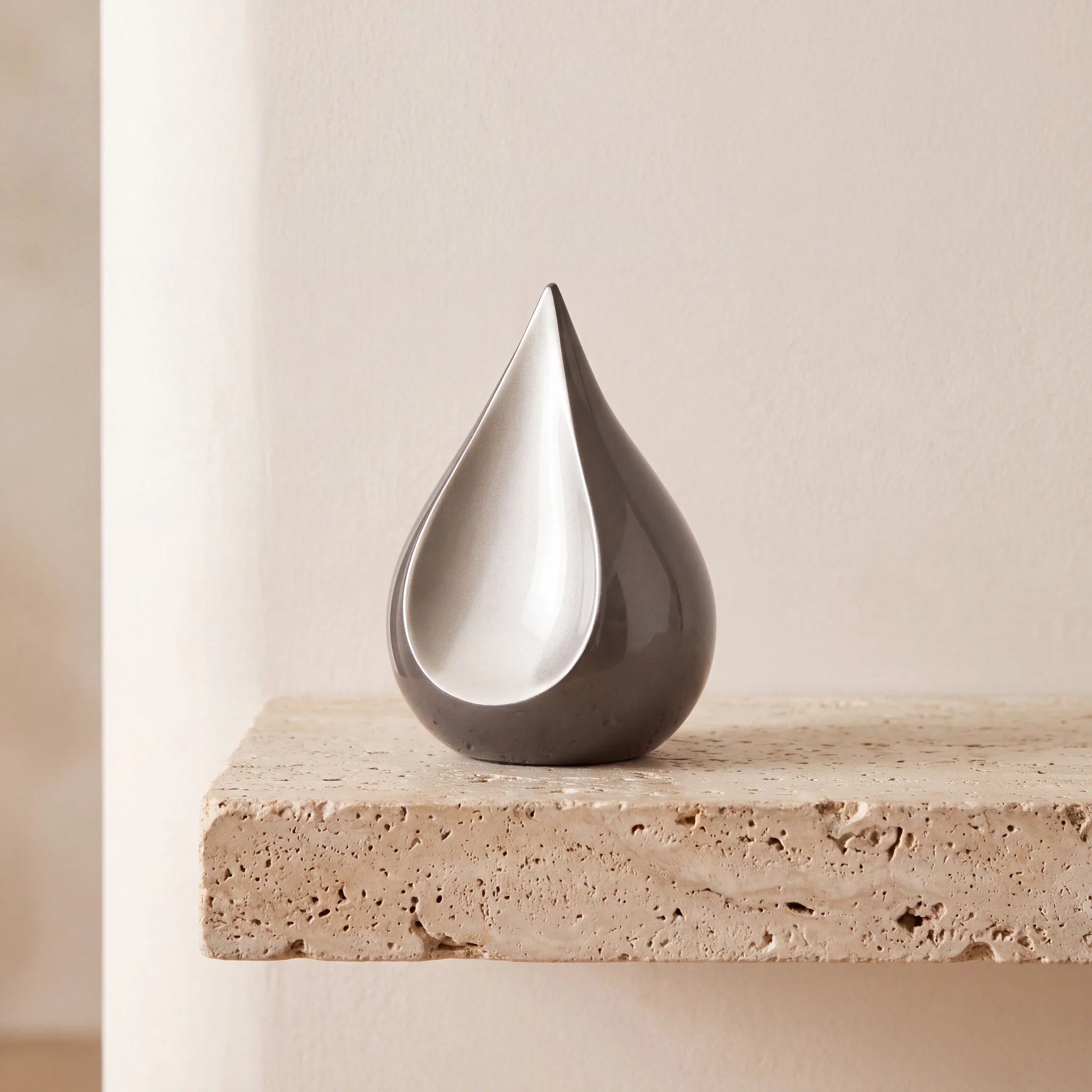 Odyssee-Metal-Teardrop-Keepsake-Urn-for-Ashes-in-Grey-Travertine-Ledge