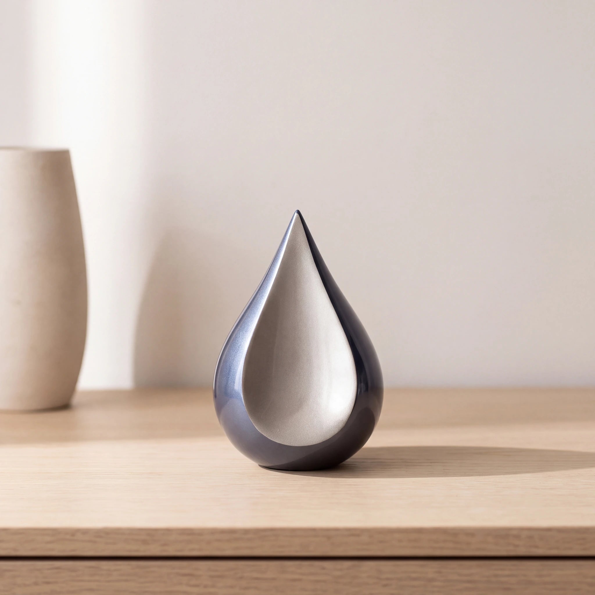 Odyssee-Metal-Teardrop-Keepsake-Urn-for-Ashes-in-Midnight-Blue-and-Silver-Oak-Console