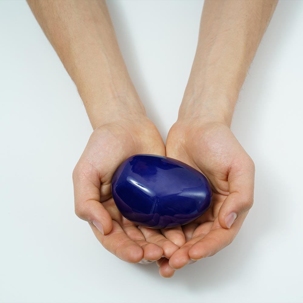 Palm Stone Ashes Keepsake Urn Metallic Blue in Hands